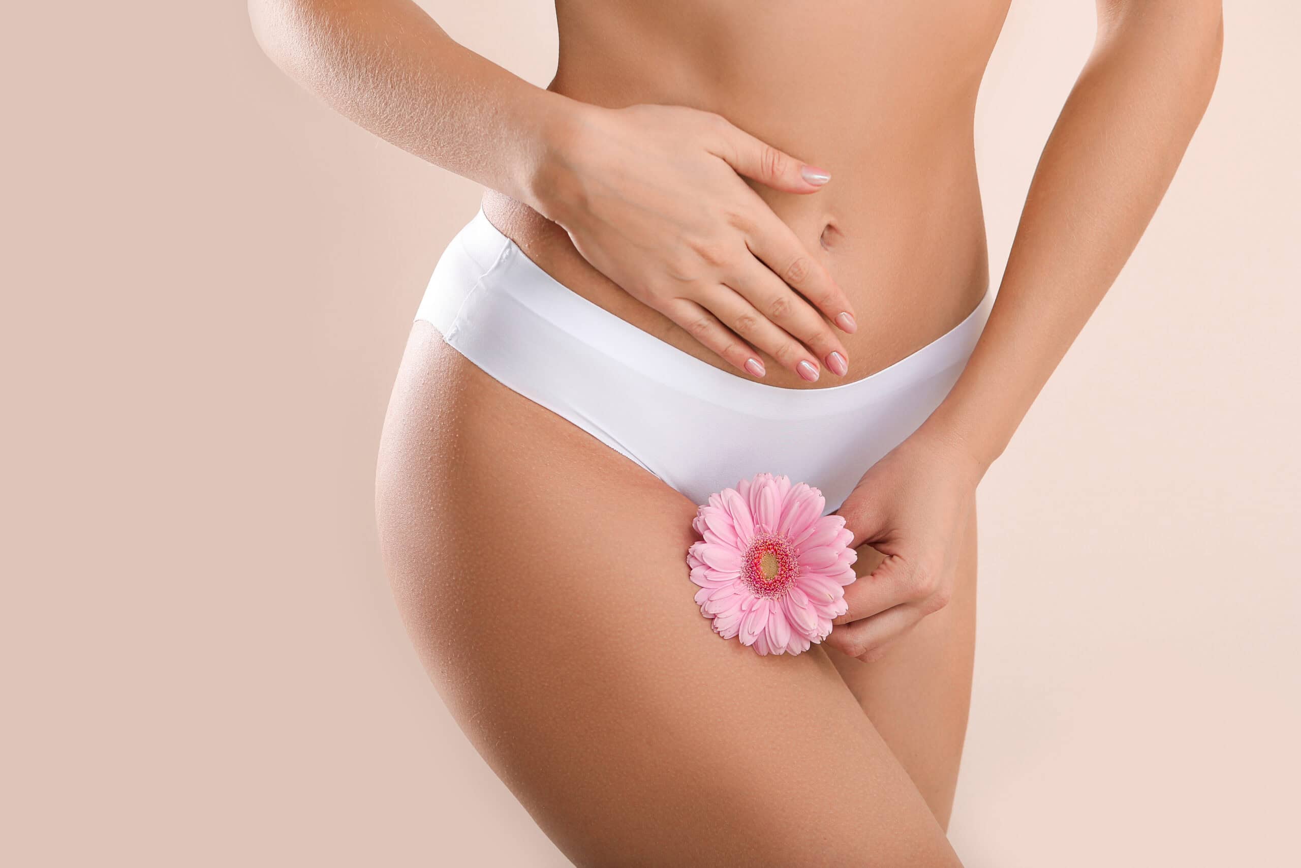 Young,woman,with,flower,on,light,background.,gynecology,concept